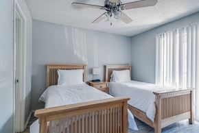 Nashville apartment for rent - A bedroom with two beds and a ceiling fan.