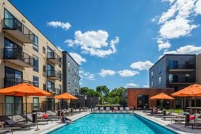 St Paul apartment for rent - Vintage on Selby | St. Paul, MN |a swimming pool with umbrellas in front of some buildings