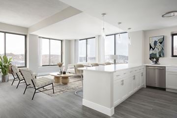 Haverhill apartment for rent - A modern kitchen with white cabinets and a large island.