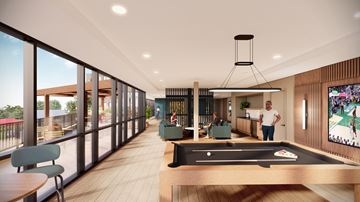 Wauwatosa apartment for rent - A man is standing in a room with a pool table and a television.