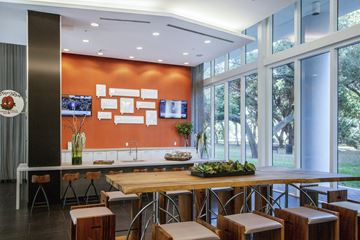 Fort Lauderdale apartment for rent - a kitchen with a wooden table and chairs and large windows
