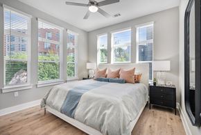 Asheville apartment for rent - A bedroom with a bed, dresser, and a ceiling fan.