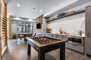 Asheville apartment for rent - A pool table is in the middle of a kitchen and dining room.