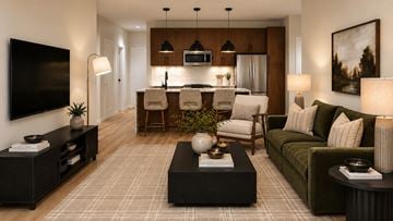 Dousman apartment for rent - A modern living room with a dark wooden coffee table and a green sofa.