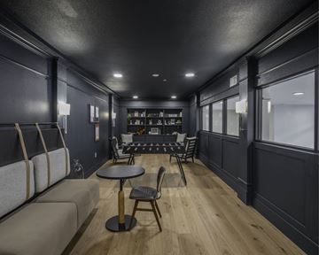 Shenandoah apartment for rent - A modern living room with a grey sofa, a black table and a wooden floor.
