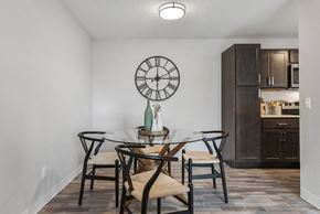 Coon Rapids apartment for rent - a dining room with a table and chairs and a clock on the wall