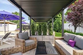 Medford apartment for rent - A patio with a wicker sofa, chairs, and a table.