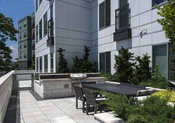 Landscaped courtyard with dining and grilling areas