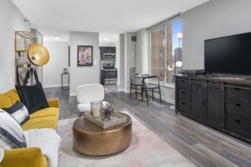 Chicago apartment for rent - A modern living room with a yellow sofa and a wooden coffee table.