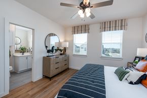 San Antonio apartment for rent - A bedroom with a large bed and a ceiling fan.