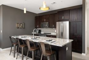 Oak Creek apartment for rent - a kitchen with a marble counter top and stainless steel refrigerator