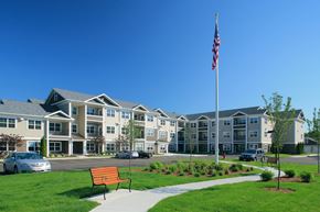 Wilmington apartment for rent - A large building with a flag on top of a pole.