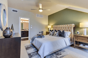 Dallas apartment for rent - A bedroom with a large bed and a wooden dresser.