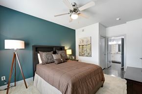 Dallas apartment for rent - a bedroom with a bed and a ceiling fan