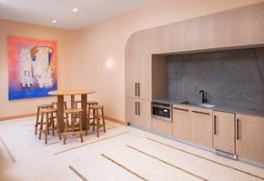 Miami apartment for rent - A kitchen with a table and chairs and a painting on the wall.