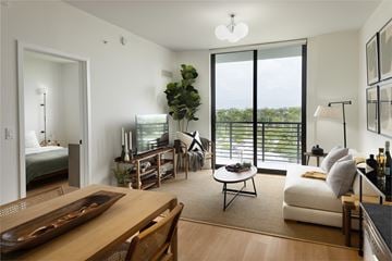 Miami apartment for rent - A living room with a wooden table and a white couch.