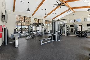 San Antonio apartment for rent - a gym with weights and other exercise equipment and windows