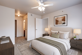 Dallas apartment for rent - A bedroom with a large bed and a ceiling fan.