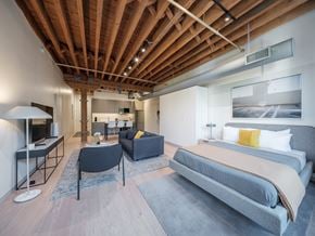 Chicago apartment for rent - A modern bedroom with a large bed and a living area.