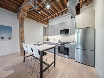 Chicago apartment for rent - A kitchen with a wooden beam ceiling and stainless steel appliances.
