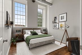 Cohoes apartment for rent - A bedroom with a bed, nightstand, and a chair.