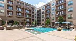 Houston apartment for rent - A large swimming pool in front of apartment buildings.