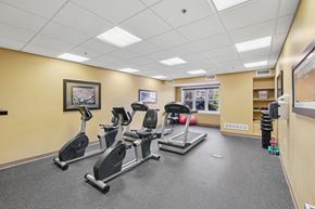 Independence apartment for rent - A gym room with treadmills, elliptical machines, and a weight rack.