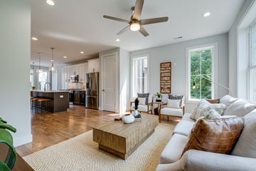 Nashville townhouse for rent - A modern living room with a white couch and a wooden coffee table.