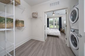 Ponte Vedra apartment for rent - a laundry room with washer and dryer and a bed in a room with