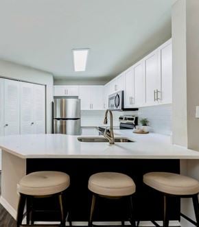 Orlando apartment for rent - A kitchen with white cabinets and a white counter top.