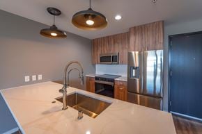 Milwaukee apartment for rent - A modern kitchen with a sink and stainless steel appliances.