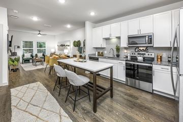 Gainesville apartment for rent - an open kitchen and living room with a table and chairs