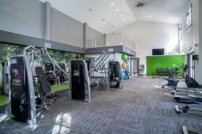 Coral Springs apartment for rent - Fitness center with treadmills, stationary bikes, weight machines, vaulted ceiling and ceiling fans