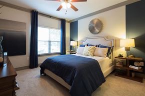 Alpharetta apartment for rent - a bedroom with a bed and a ceiling fan