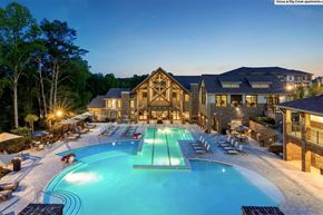 Alpharetta apartment for rent - a large swimming pool in front of a hotel at night