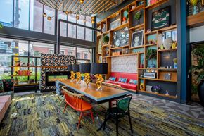 Minneapolis apartment for rent - a dining room with a table and chairs in front of a wall filled with shelves