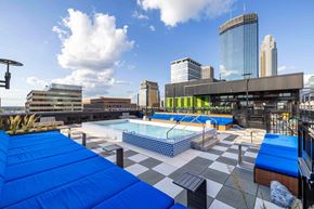 Minneapolis apartment for rent - a pool on the roof of a building with a city in the background