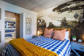 Minneapolis apartment for rent - a bedroom with a bed and a mural on the wall