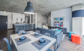 Chicago apartment for rent - A modern dining room with a white table and grey chairs.