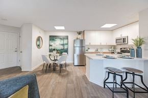 Tampa apartment for rent - A kitchen with a white table and chairs.