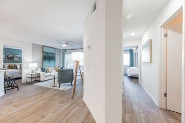 Tampa apartment for rent - A living room with a white couch and a grey chair.