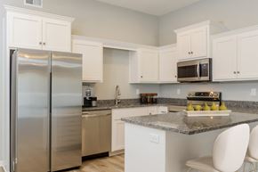 Belton apartment for rent - a kitchen with white cabinets and granite countertops