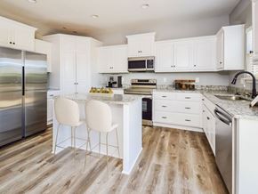 Pleasant Hill apartment for rent - a kitchen with white cabinets and stainless steel appliances