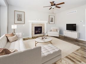 Pleasant Hill apartment for rent - Studio Apartments in Pleasant Hill, MO - Tall Grass - Cozy Living Room With Luxury Vinyl Plank Flooring, Fireplace, Ceiling Fan, And Window