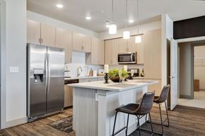 Aurora apartment for rent - a kitchen with a large island and stainless steel appliances