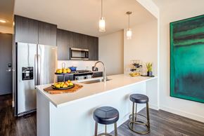Chicago apartment for rent - a kitchen with two stools in front of a counter top