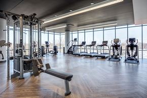 Chicago apartment for rent - a gym with cardio machines and a view of a window