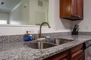 Myrtle Beach apartment for rent - a kitchen with granite counter tops and a sink