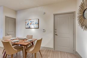Grand Prairie apartment for rent - A dining room with a wooden table and chairs.