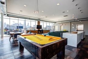 Chicago apartment for rent - a pool table in a party room with a view of the city
